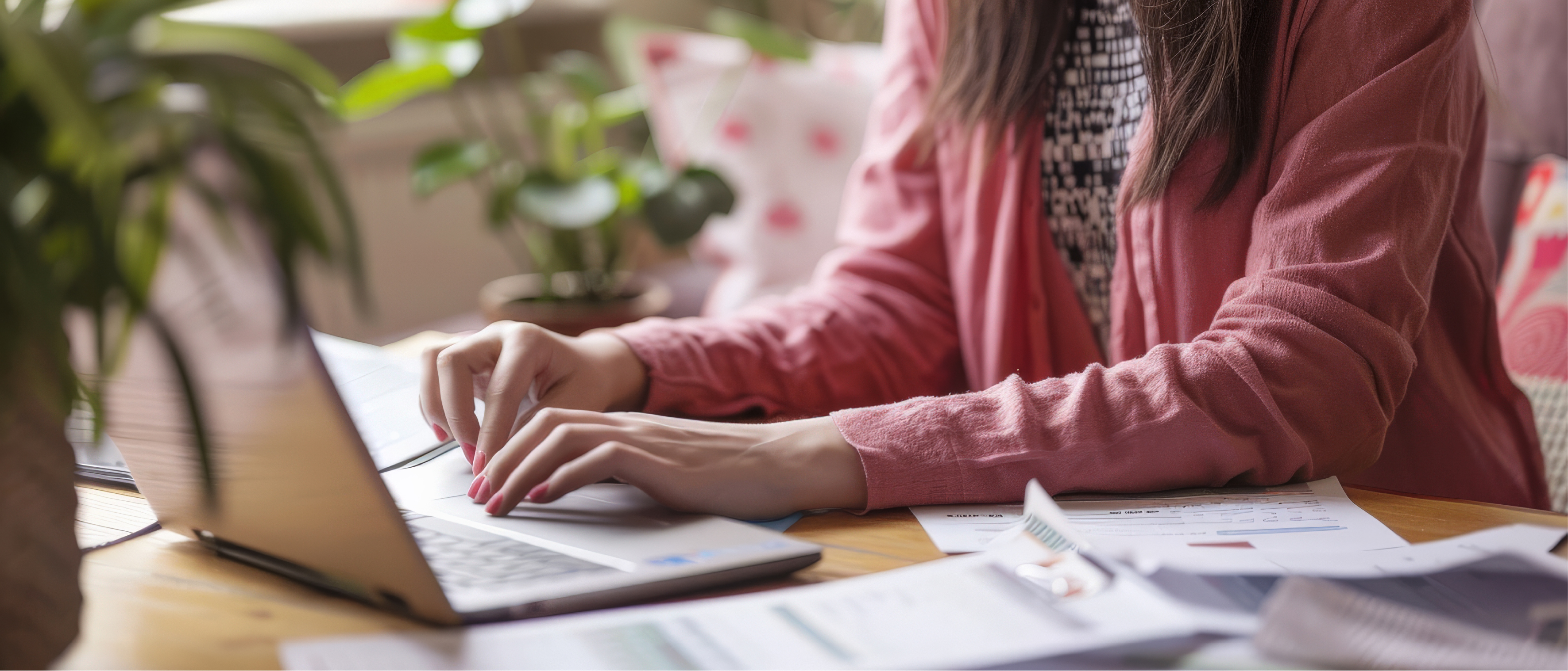 Kobieta siedzi i pracuje przy laptopie